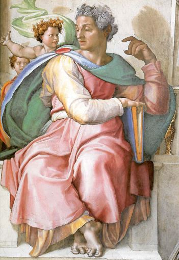 Clean-shaven man with olive skin in a pink robe with a blue cloak seated, holding a large book listening to a cherub seated at his right shoulder.